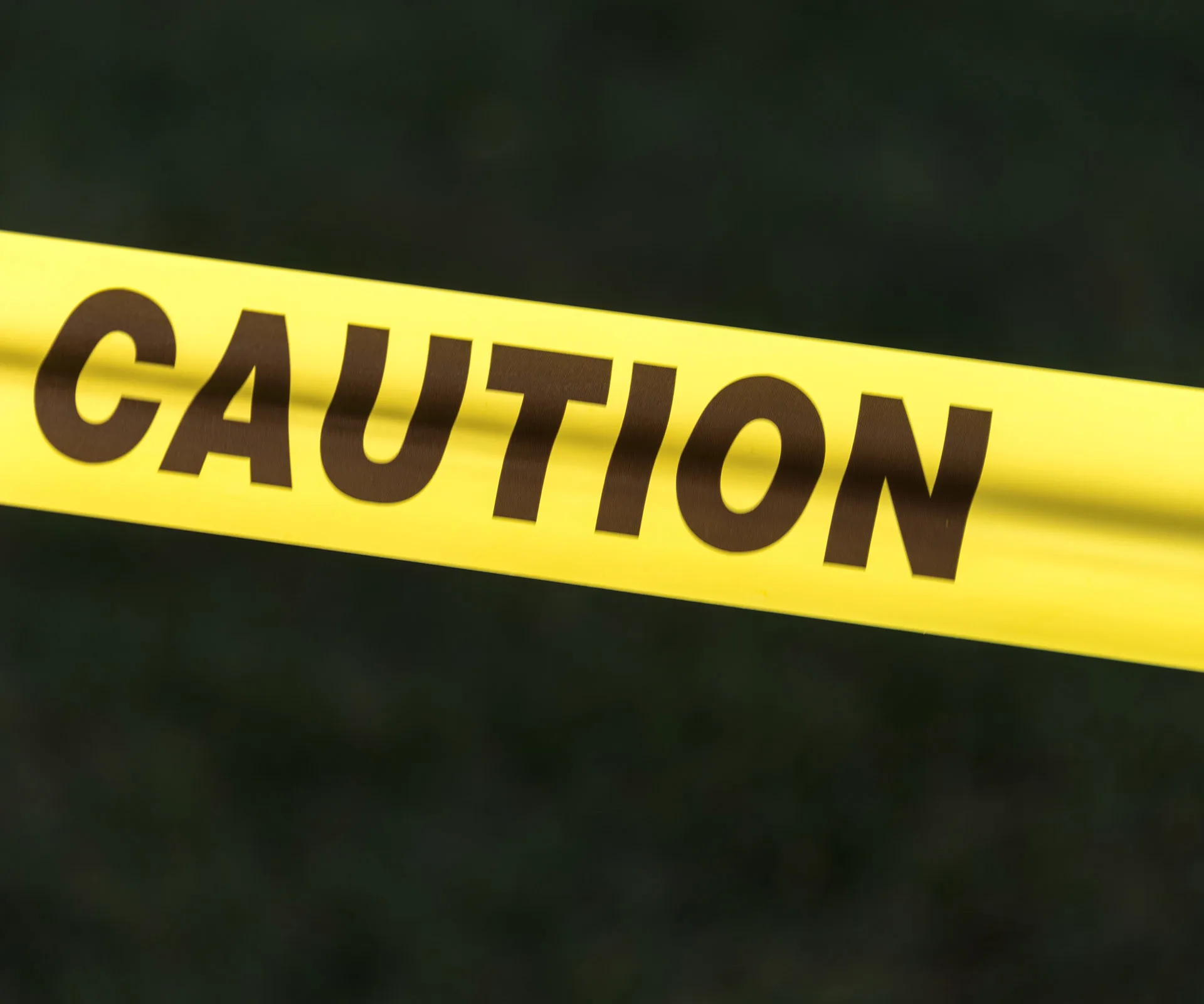 Yellow caution tape with "CAUTION" written in bold black letters.