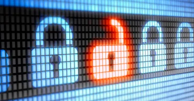 Digital lock icons, one unlocked and glowing orange, representing security breach concept.