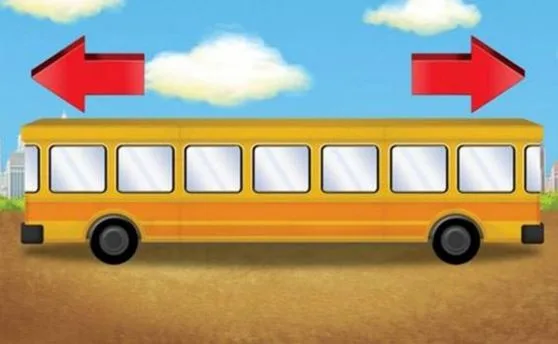 A yellow school bus with windows and two red arrows pointing in opposite directions on a sunny day.