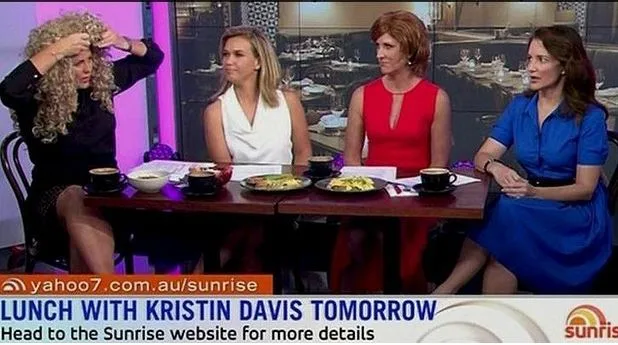Four women sit at a table on a talk show set. A display banner reads "Lunch with Kristin Davis Tomorrow."