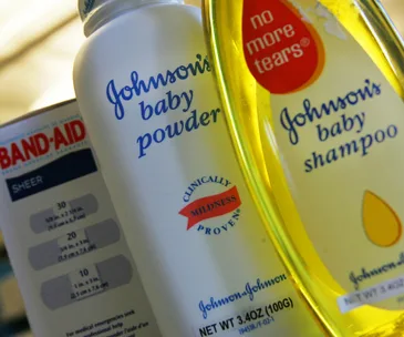 Johnson & Johnson baby powder, baby shampoo, and Band-Aid products close-up.
