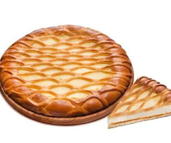 Pizza with a lattice crust, one slice cut, revealing a sweet pie-like filling on a wooden board.