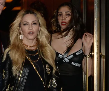Madonna with her daughter Lourdes in stylish outfits, exiting a venue, facing the camera.