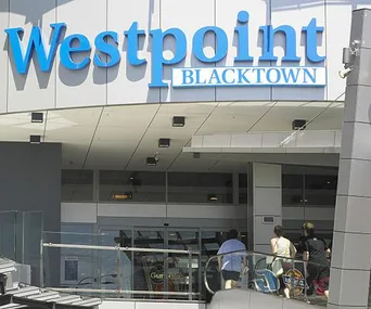 "Entrance to Westpoint Blacktown shopping center, with people walking in on a sunny day."