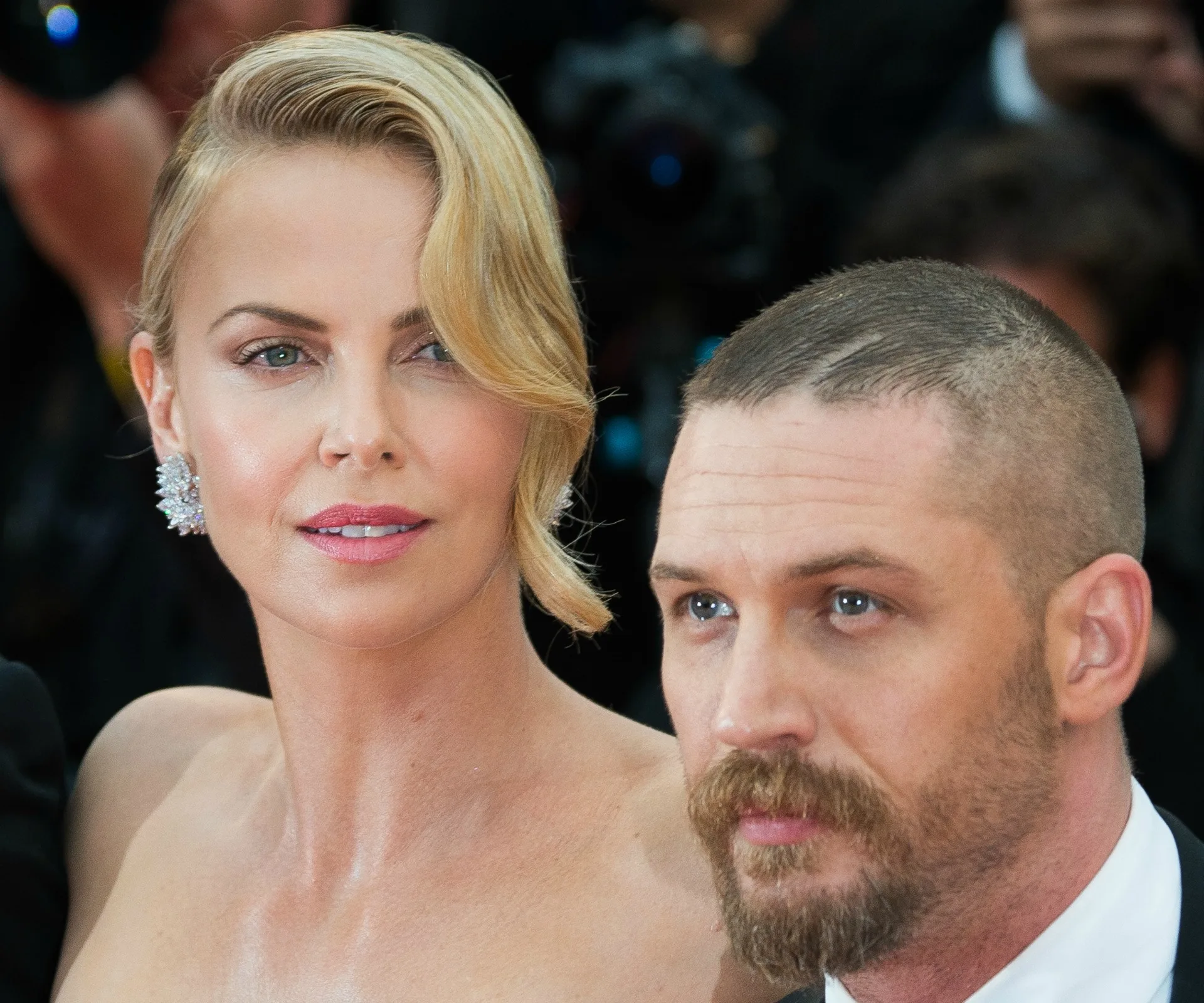 Charlize Theron and Tom Hardy at a formal event, possibly related to "Mad Max: Fury Road."