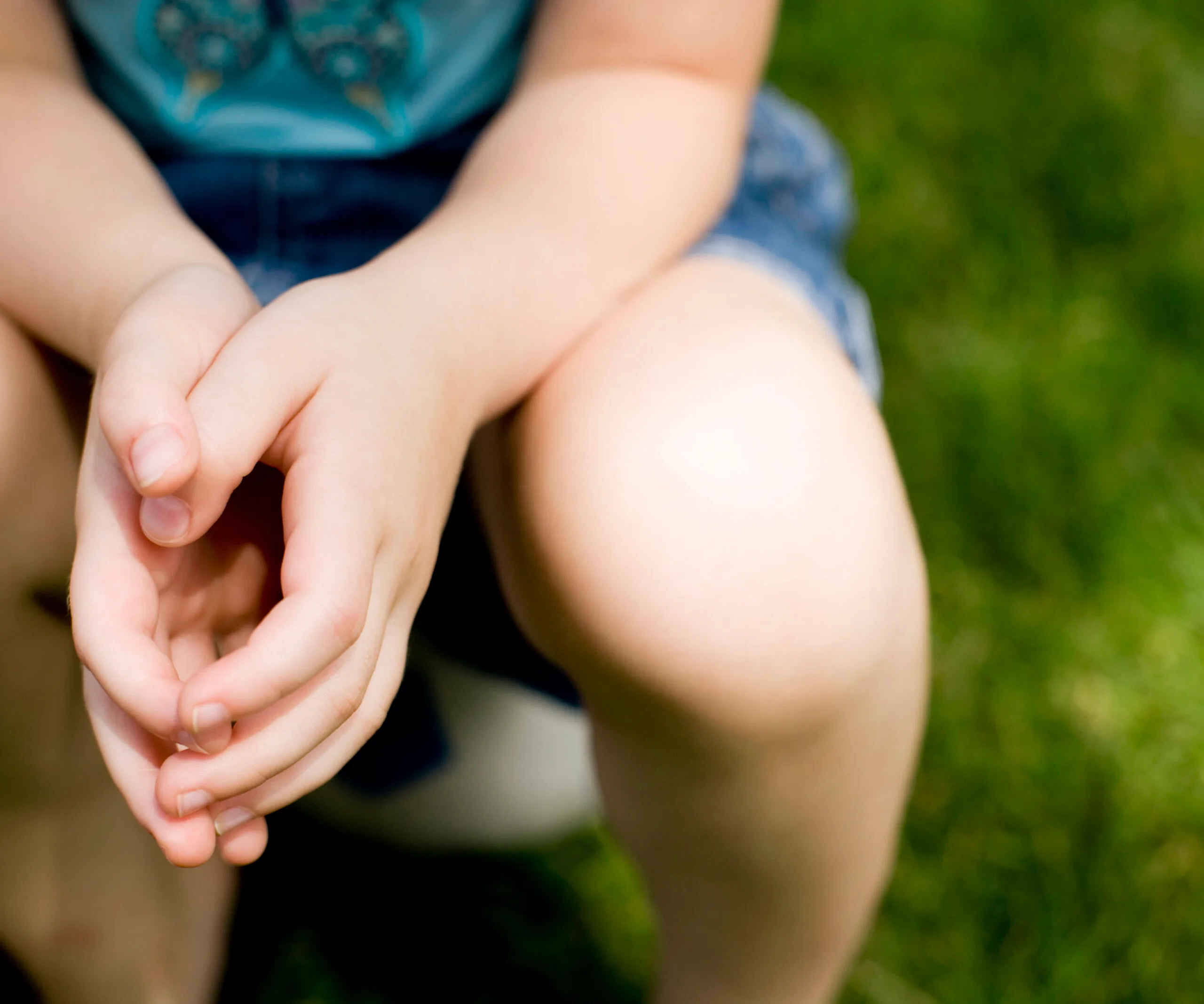 girl sitting on soccer ball