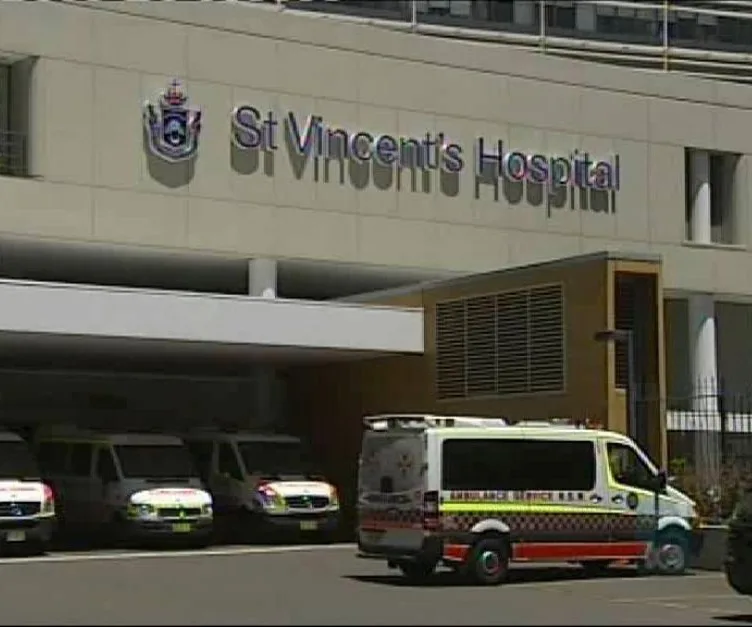 St Vincent's Hospital entrance with parked ambulances and hospital signage.