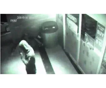 CCTV footage captures a ghostly figure walking near a closed glass door at night.