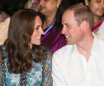 A couple smiling at each other during a public event.