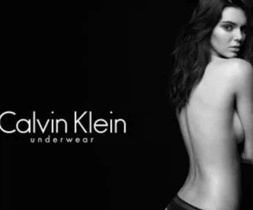 A model poses in Calvin Klein underwear black-and-white ad, showcasing the brand logo.