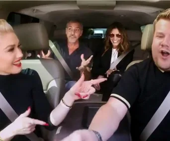 Four people in a car, laughing and talking, participating in Carpool Karaoke.