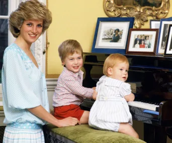 Princess Diana with her two young sons by a piano, surrounded by family photos.