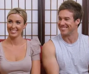 A smiling couple, Jackie and Tim, sit together on a couch in casual attire, against a backdrop of wooden panels.