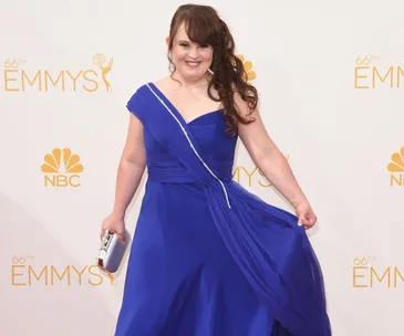 Actress in a blue dress poses at the 66th Primetime Emmy Awards.
