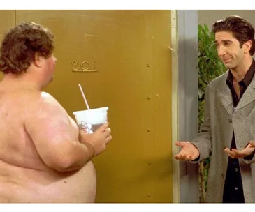 Ross with shirtless neighbor holding a drink outside apartment 201 door in "Friends."