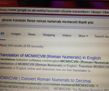 Grandma's Google search for translating Roman numerals "MCMXCVIII" with a polite "thank you."