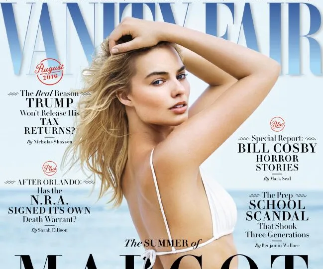 Alt text: "Magazine cover featuring a woman in a white top posing against a beach backdrop, with 'Vanity Fair' and article headlines."
