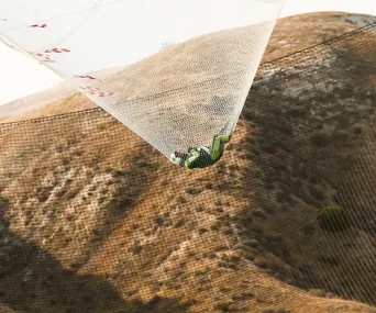 Skydiver Luke Aikins lands in a safety net. 