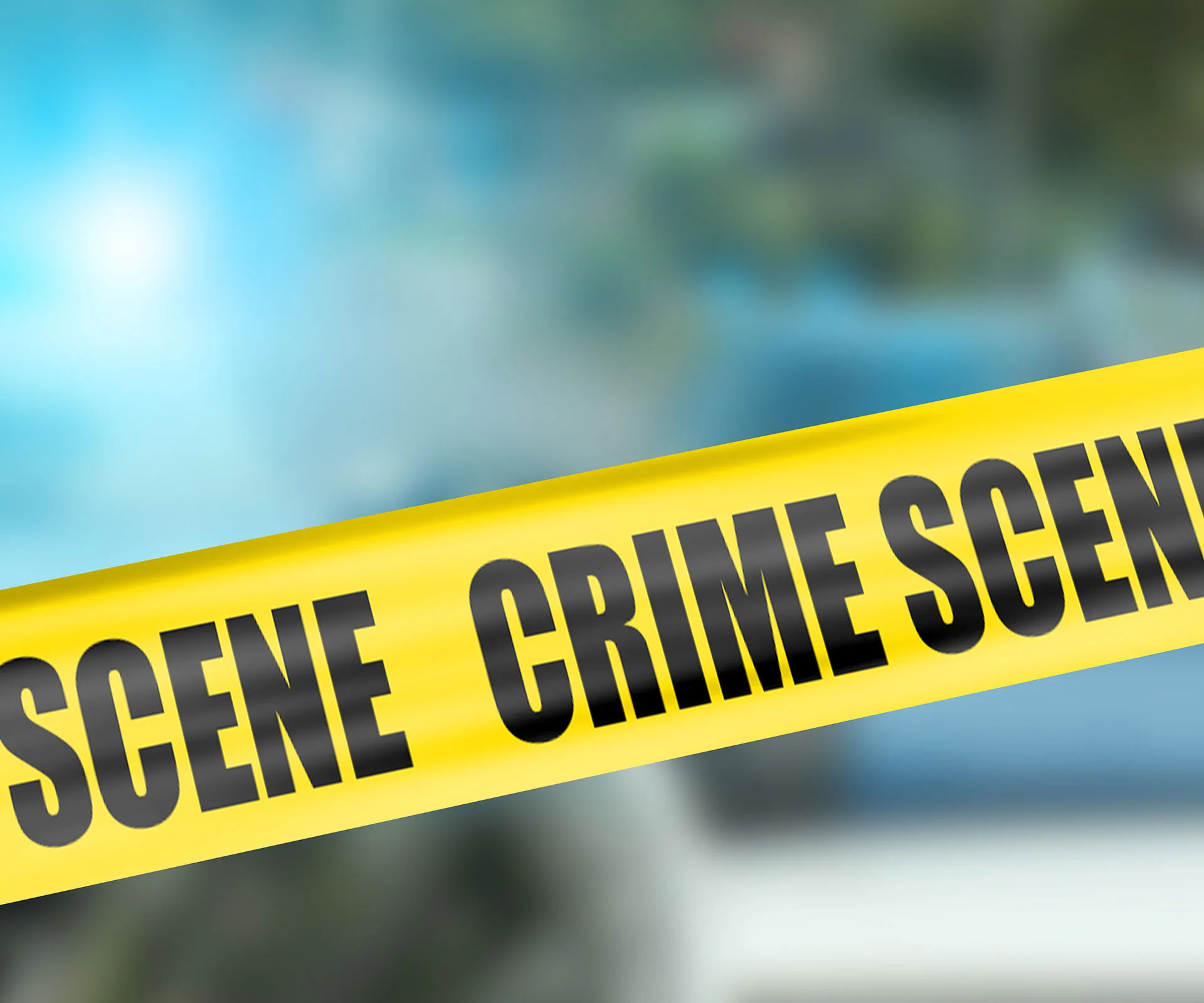 Yellow crime scene tape against a blurred background.