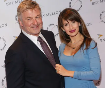 Couple smiling at a New York event, backdrop with BNY Mellon and Philharmonic logos.