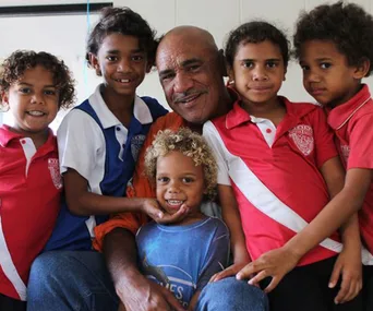 Man smiling with five children, some wearing school uniforms; Queensland's 2016 Father of the Year.