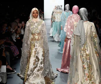 Models walk the runway wearing ornate hijabs and gowns during a fashion show at New York Fashion Week.
