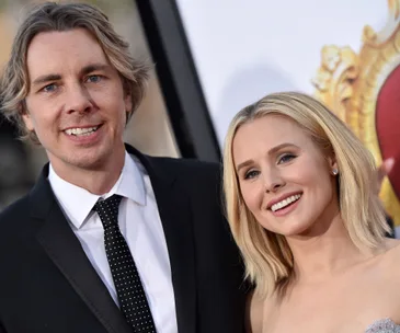 Couple in formal attire smiling at a public event.