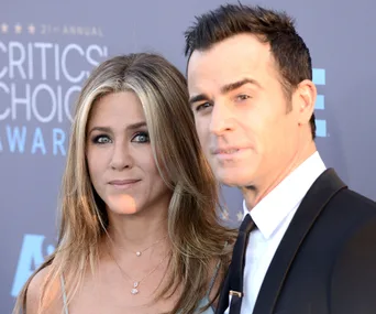 Two people posing on the red carpet at the Critics' Choice Awards.