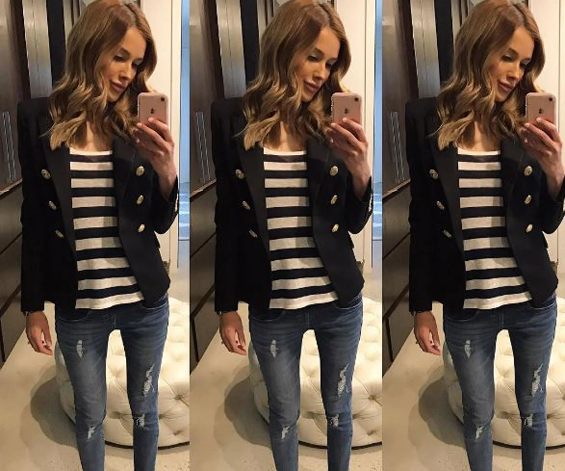 A woman takes a mirror selfie, wearing a black blazer, striped shirt, and jeans, with her reflection visible thrice.