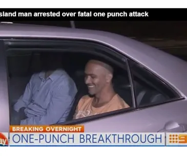 Man smiling in car after arrest in connection with fatal one-punch attack, headline shown: "ONE-PUNCH BREAKTHROUGH".