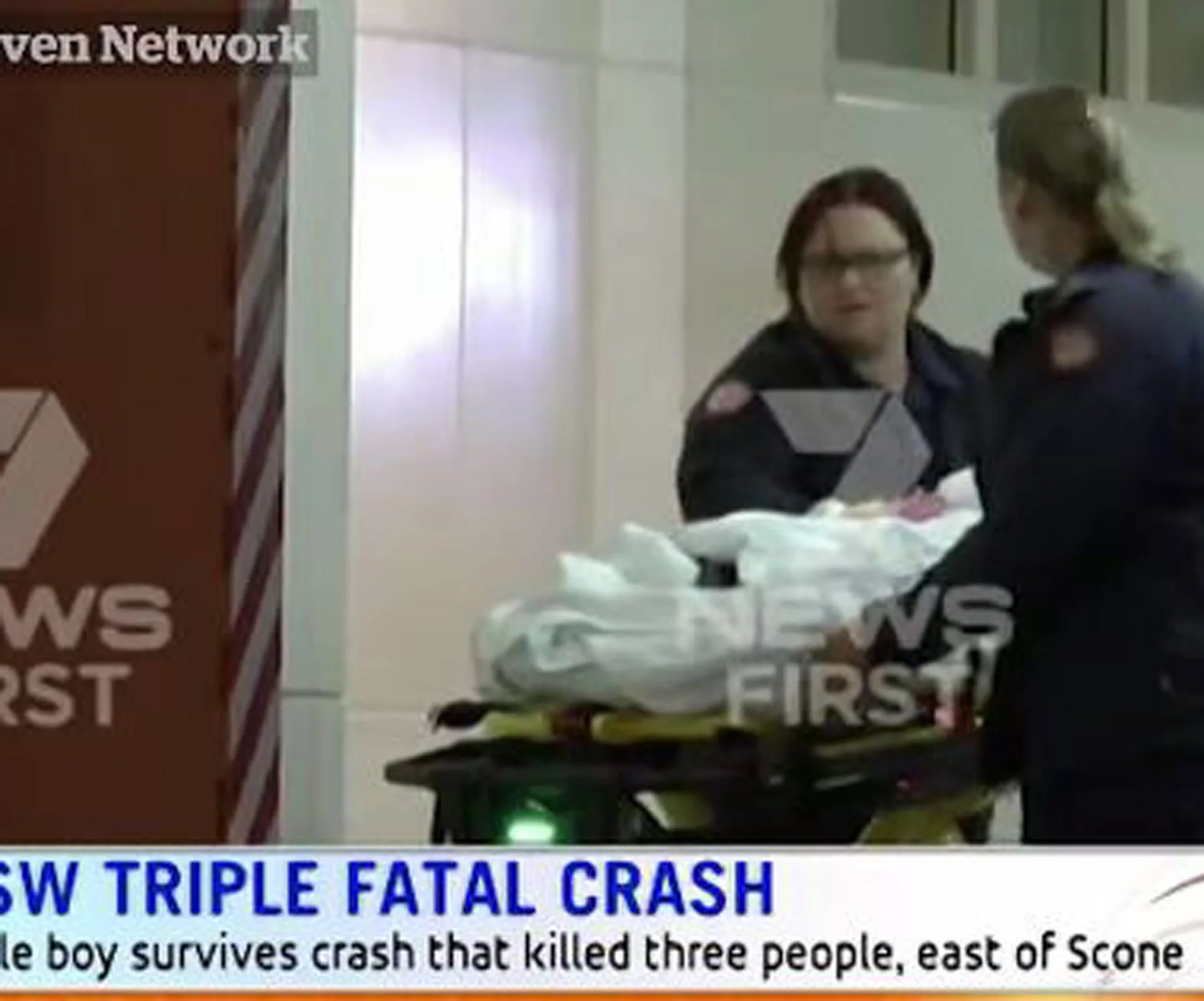 Paramedics attending to a patient on a stretcher at night, related to a triple fatal crash in Hunter Valley.