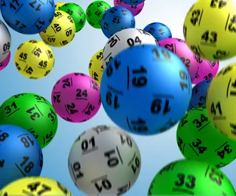 Colorful lottery balls with numbers, floating in space.