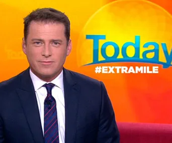 News presenter sitting on a red couch in front of an orange "Today" show backdrop.