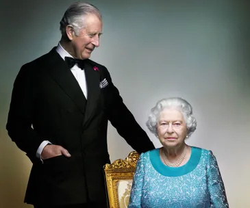 Man in a tuxedo stands beside an elderly woman seated on a golden chair, both posing formally against a neutral backdrop.