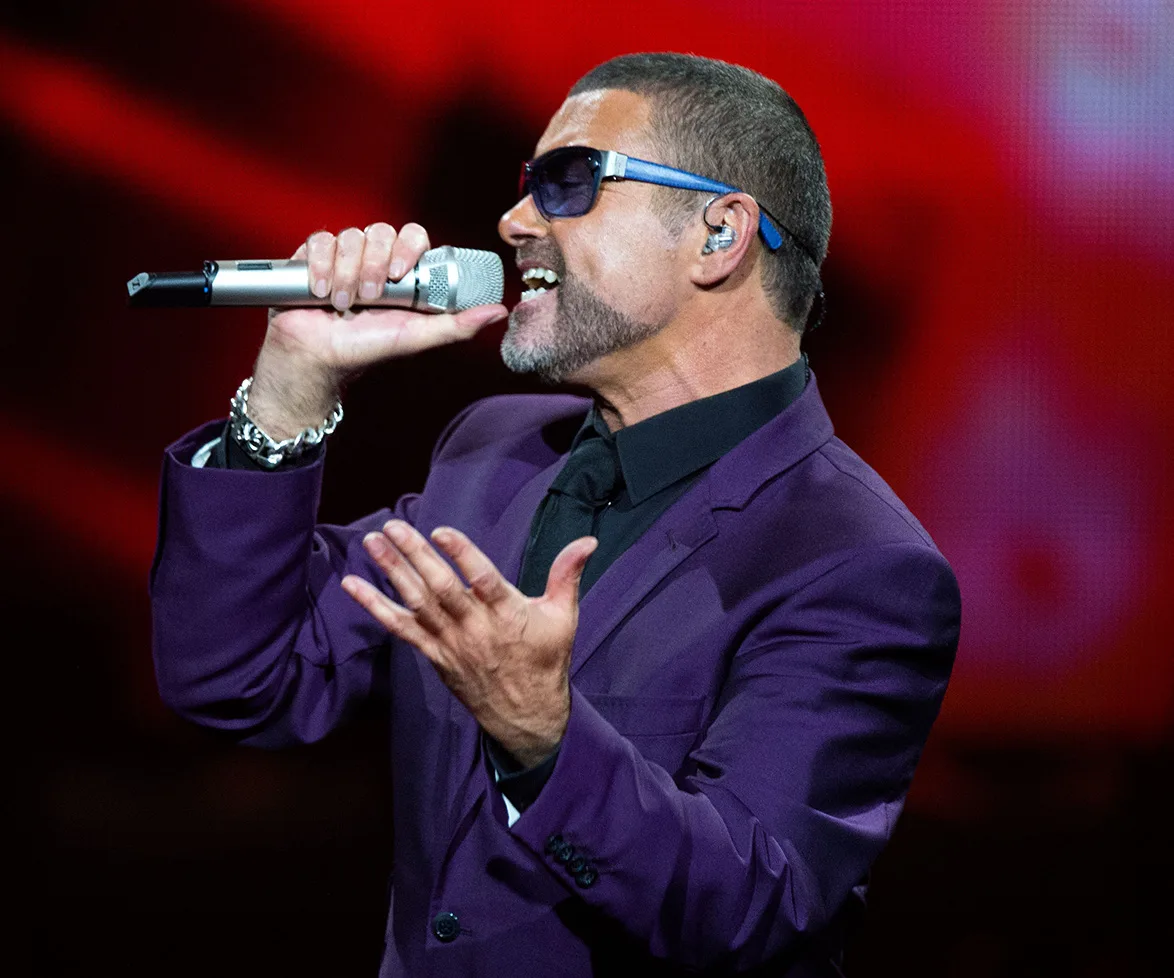 George Michael performing on stage.