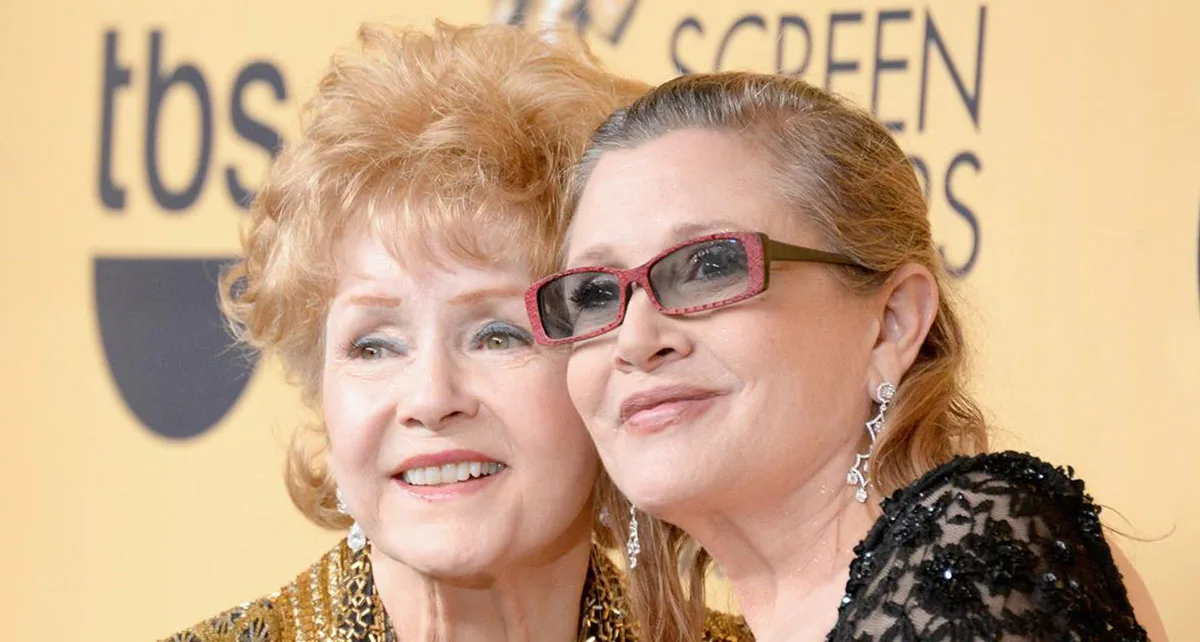 Two women smiling together at an awards event, with a yellow backdrop displaying "tbs" and "Screen Actors Guild".