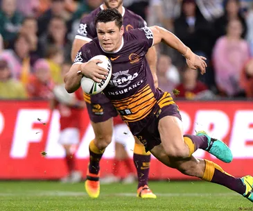 Rugby player in Brisbane Broncos uniform running with the ball during a match.