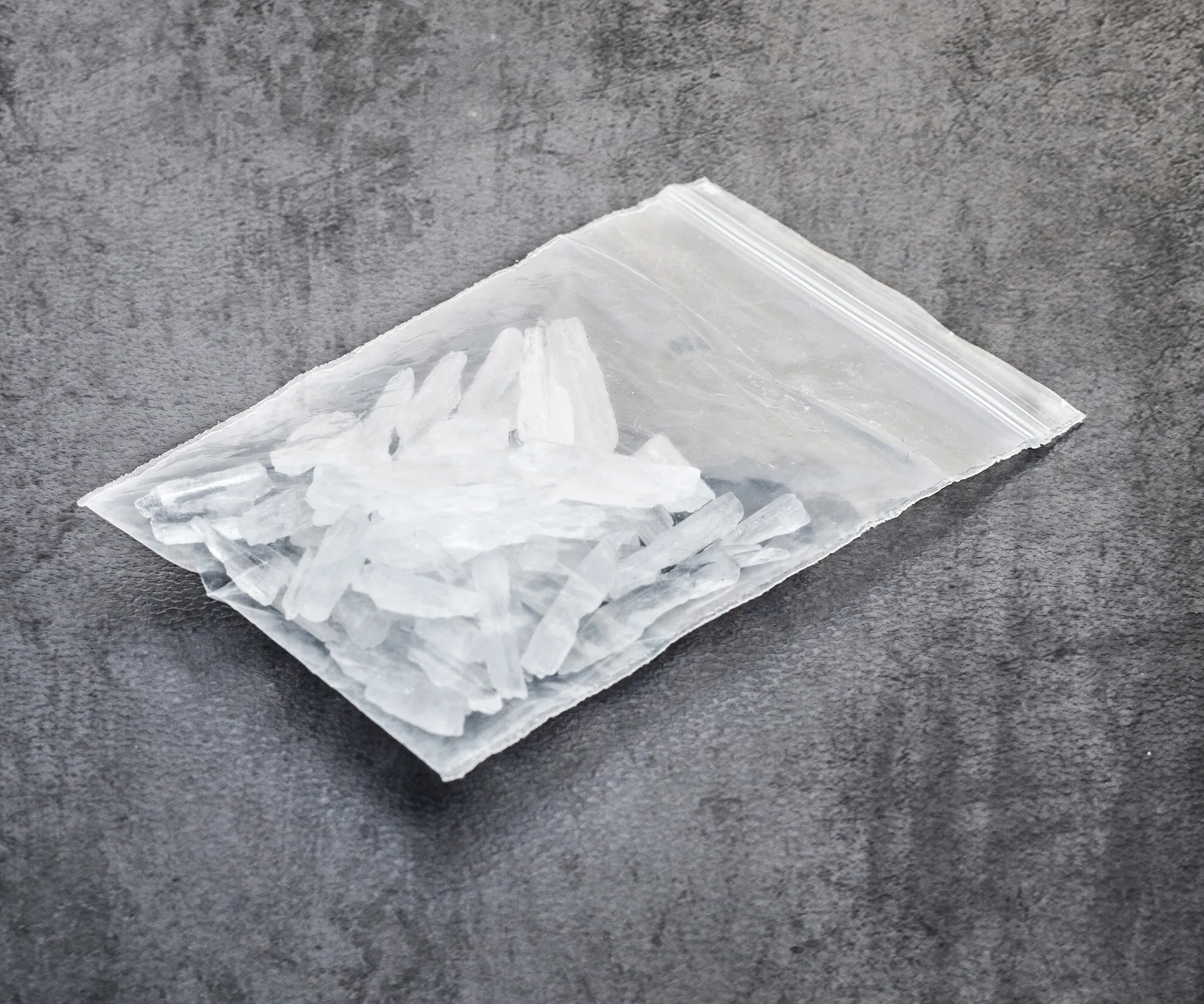 A bag of crystal meth on a gray surface, highlighting drug-related issues in an Australian city.