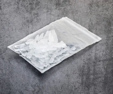 A bag of crystal meth on a gray surface, highlighting drug-related issues in an Australian city.