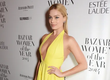 Person in a yellow dress at Harper's Bazaar Women of the Year 2014 event.