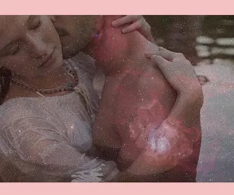 Couple embracing with an overlay of a starry nebula background.