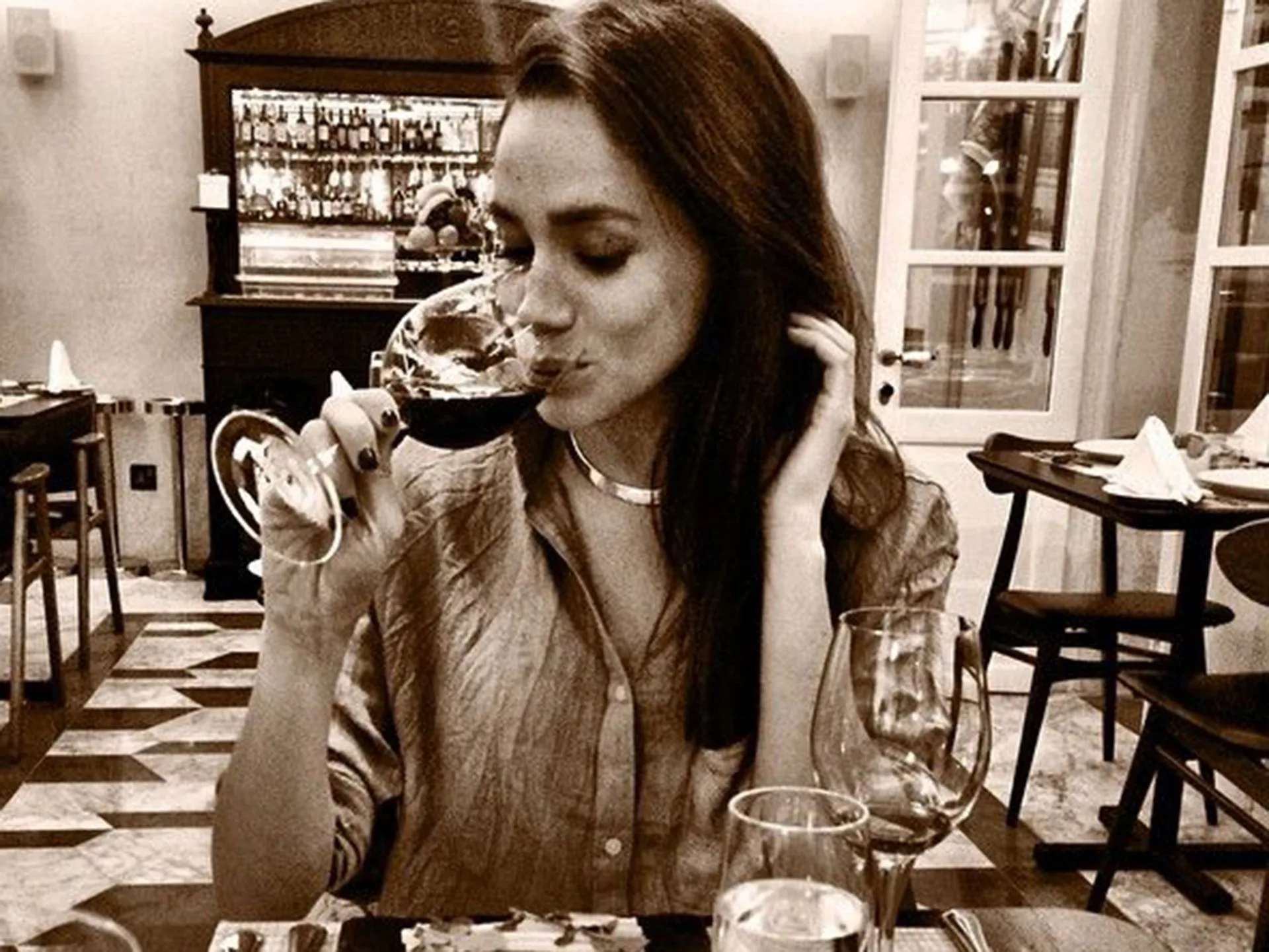 Meghan Markle drinking wine