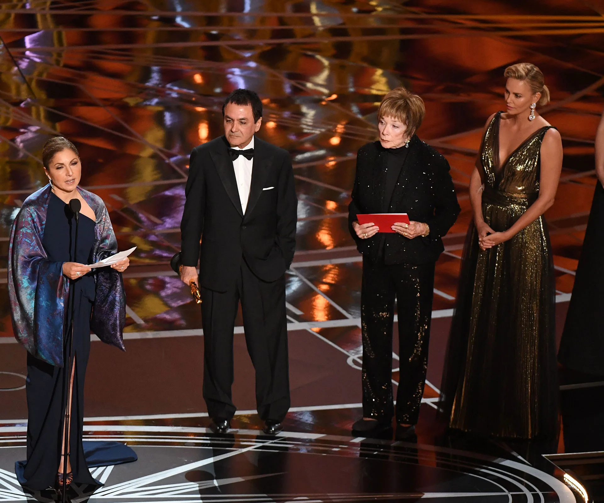 Speakers on stage at the Oscars 2017; Anousheh Ansari reading Asghar Farhadi's statement, standing with others.