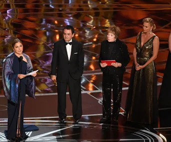 Speakers on stage at the Oscars 2017; Anousheh Ansari reading Asghar Farhadi's statement, standing with others.