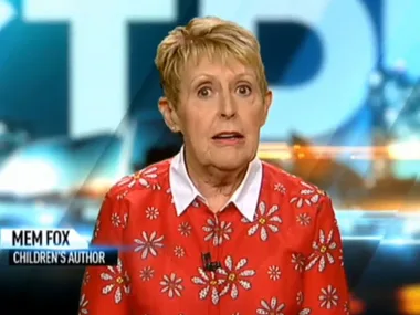 Children's author Mem Fox appears on a television screen wearing a floral red blouse.