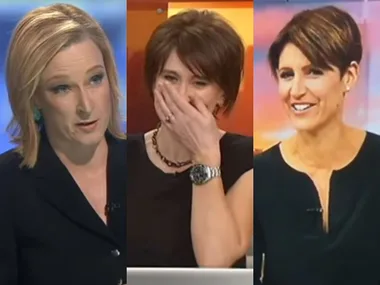 Three women in news anchor attire, one speaking, another laughing with hand over mouth, the third smiling.