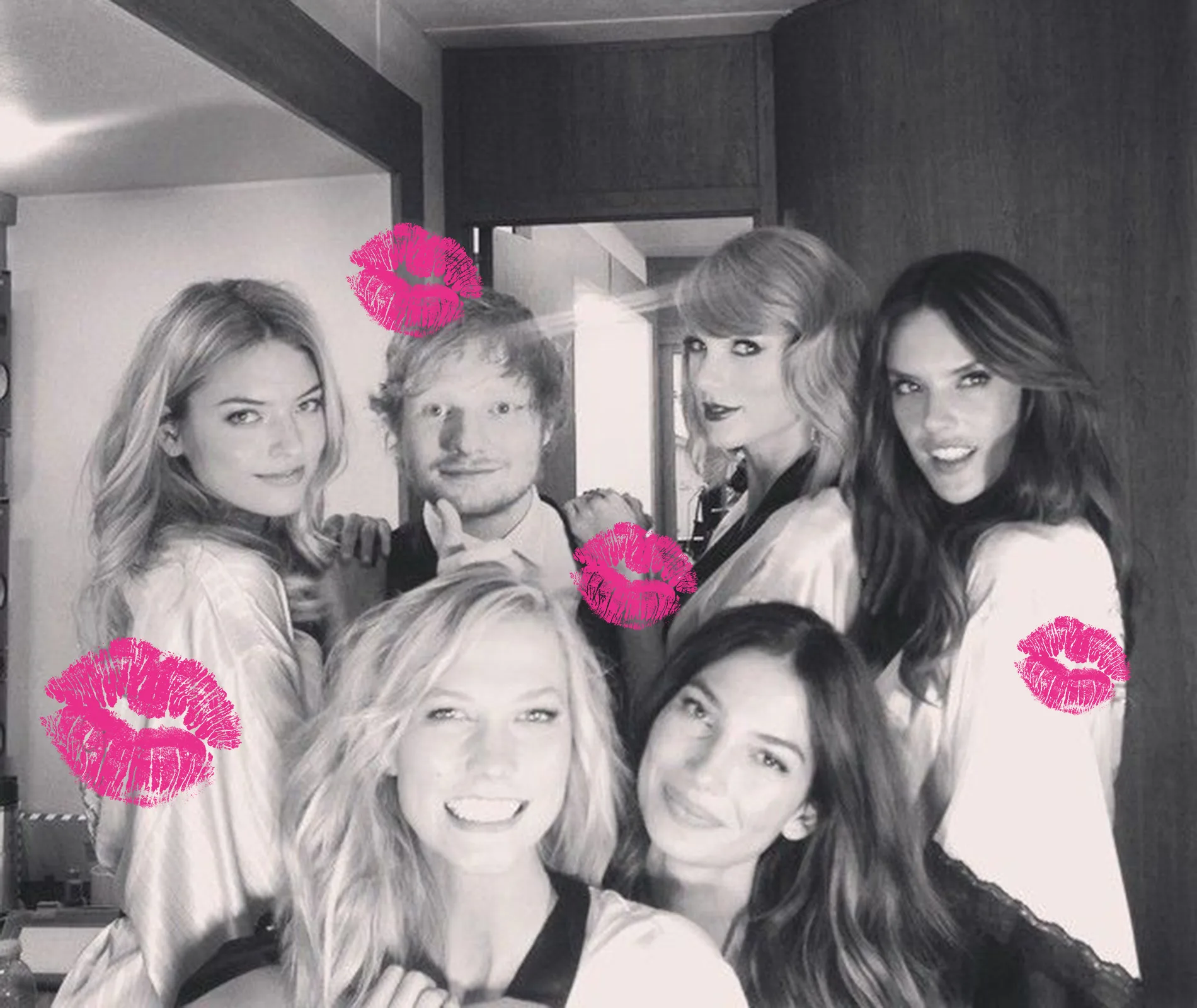 A group of smiling people posing for a photo. Pink lipstick marks are added to the image.
