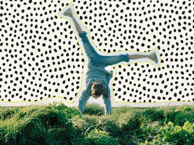 A person doing a cartwheel on grass with a dotted pattern background.