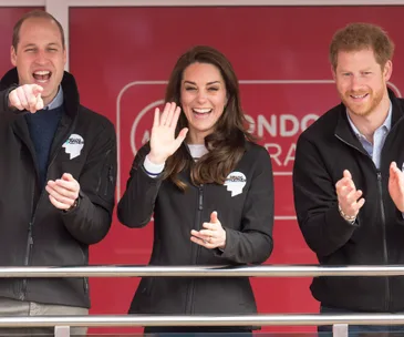 Royal family members cheering at the 2017 London Marathon in casual attire, laughing and clapping from a balcony.