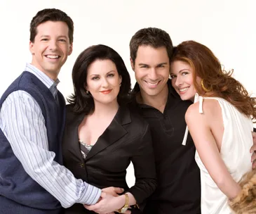 Cast of "Will & Grace" revival smiling and posing together.